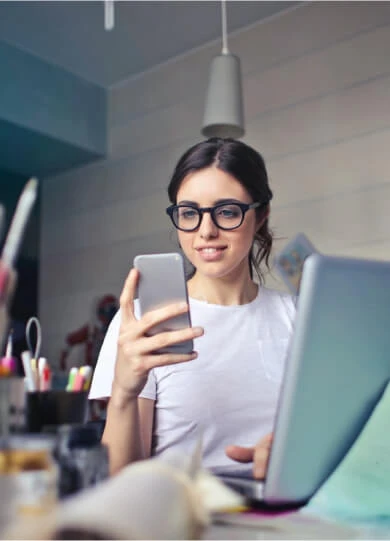 Growth Lab employee looking at their phone and smiling.