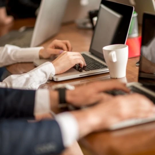 law firm marketers sitting at a desk with coffee.