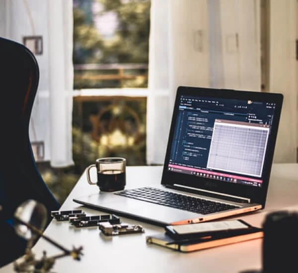 lap top and coffee at a desk.