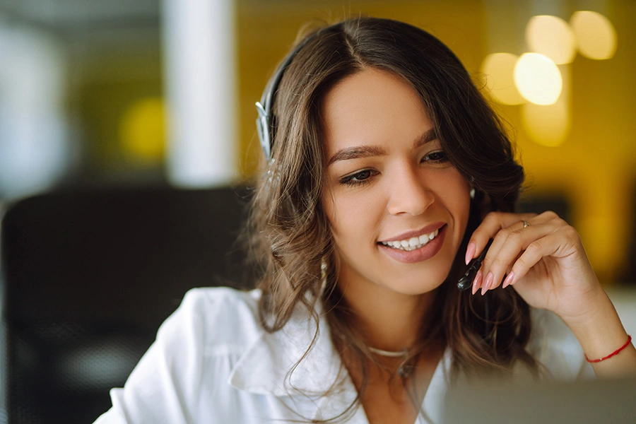 Professional woman smiling while talking to customer on the phone