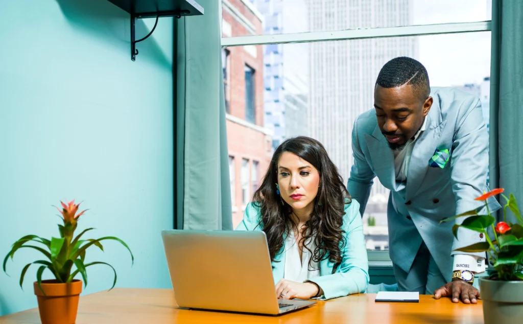 Man and woman looking at a computer.