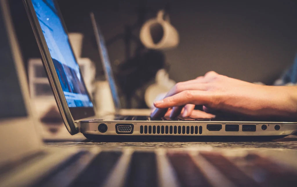 close up of hands on a key board typing a blog for a law firm website.