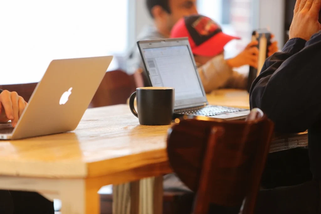 Lawyers drafting content on laptops at a table. 