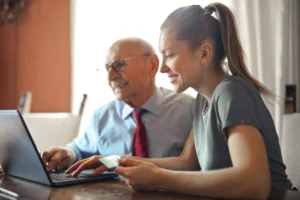 Two people working on a computer.