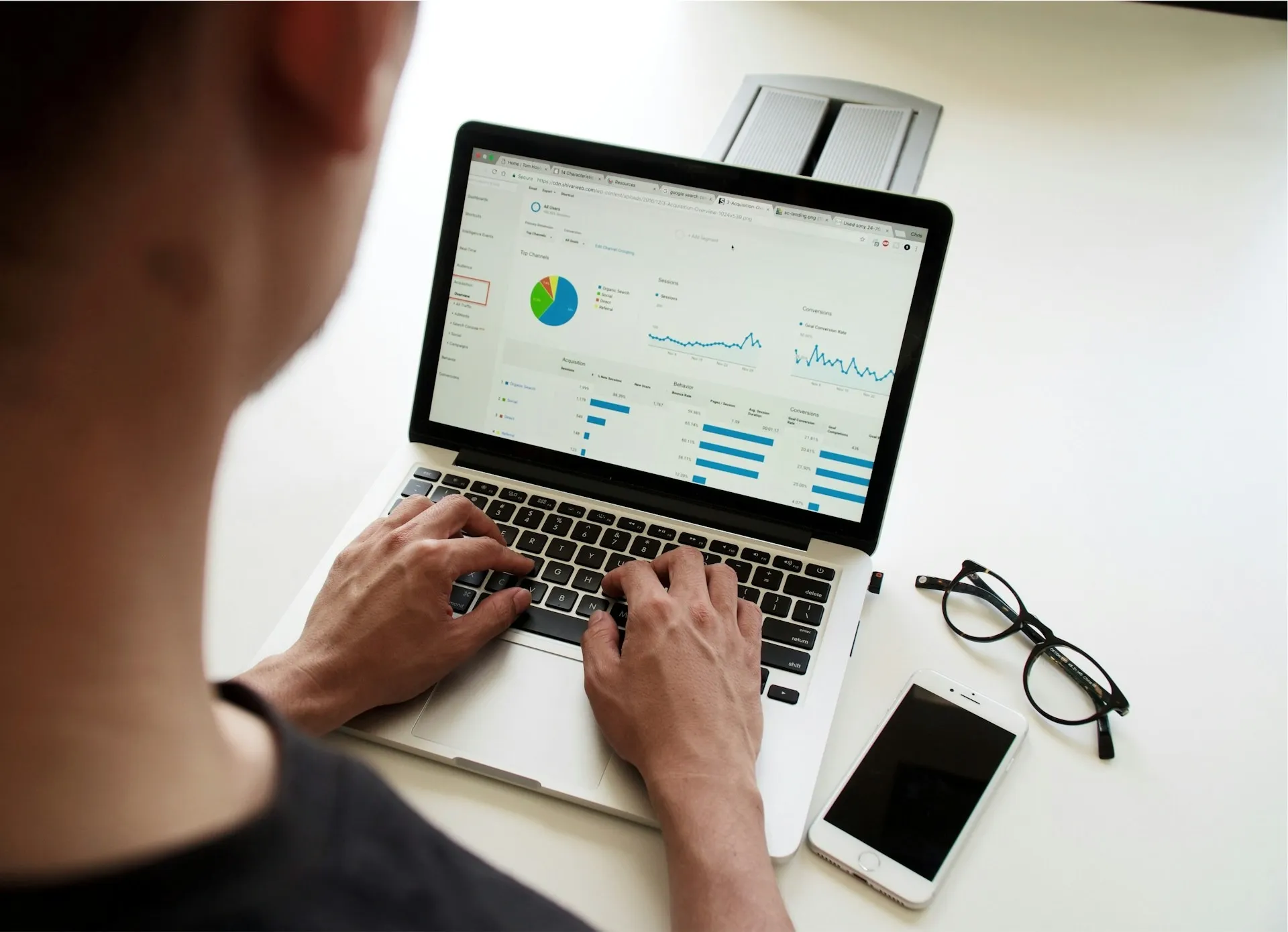 A man reviewing analytics data on a laptop.